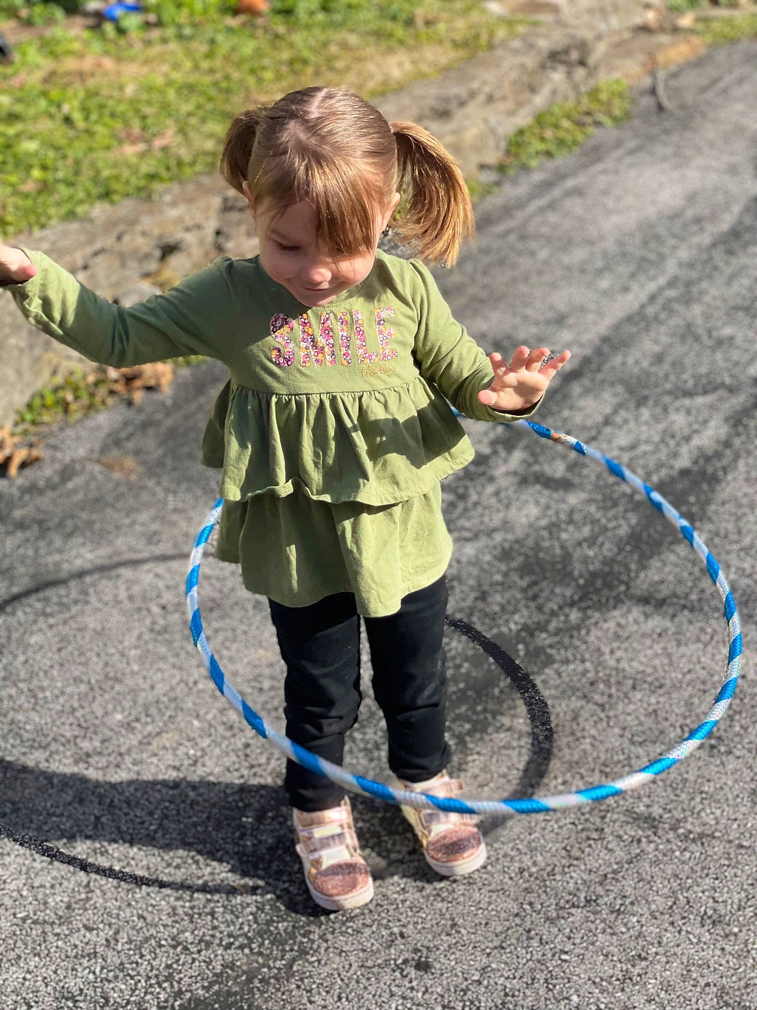 Annie is registered to the contest to win money with this photo: asphalt, child, electric_blue, event, fun, grass, leisure, person, plant, play, recreation, rope, tire, toddler, toy, walking