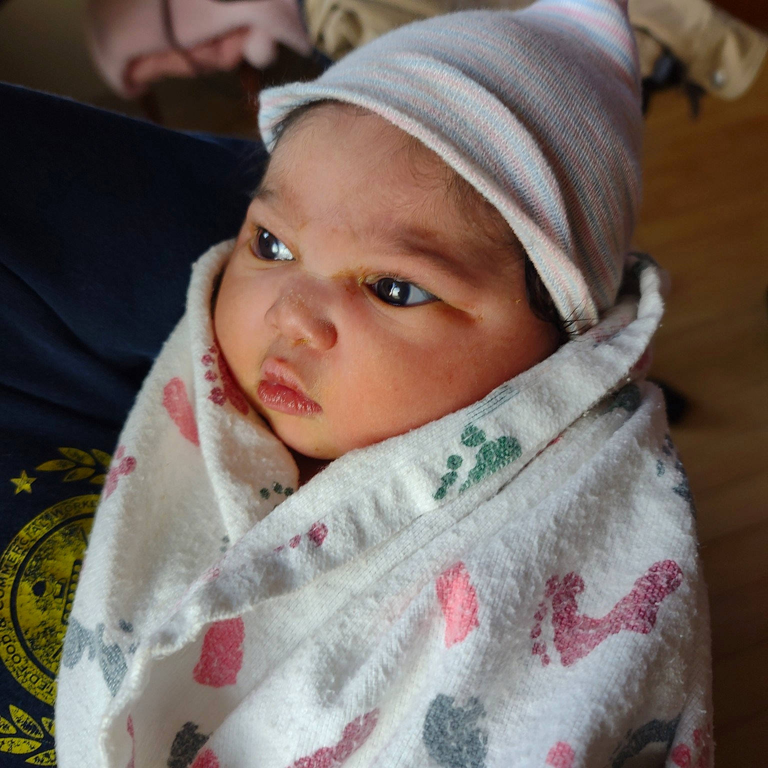 Damayiah is registered to the contest to win money with this photo: baby, baby_toddler_clothing, cap, cheek, child, collar, comfort, eyebrow, eyelash, face, happy, headwear, linens, lip, nose, pattern, person, sitting, skin, sleeve