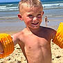child, boy, beach, sand, ocean, floaties, swimwear, sunlight, smile, summer, water, waves, sunny, outdoor, playful, happy, vacation, holiday, barechested, hair