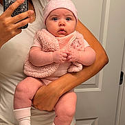 Zuri joined the competition — help win amazing prizes! adult, baby, casual_clothing, child, closeup, curious_expression, door, hand, hat, holding, indoor, infant, mirror_selfie, person, phone, phone_case, pink_clothing, portrait, socks, soft_texture