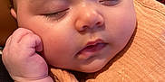 Zuri is registered to the contest to win money with this photo: baby, blanket, cheeks, closeup, cute, eyelashes, face, fingers, hand, indoors, infant, mouth, newborn, nose, peaceful, portrait, resting, skin, sleeping, soft_texture