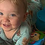 Meka joined the competition — help win amazing prizes! baby, child, smiling, blue_eyes, pajamas, bird_pattern, toy, indoor, close_up, face, cute, infant, happy, person, playtime, colorful, soft_light, young_child, cheerful, skin