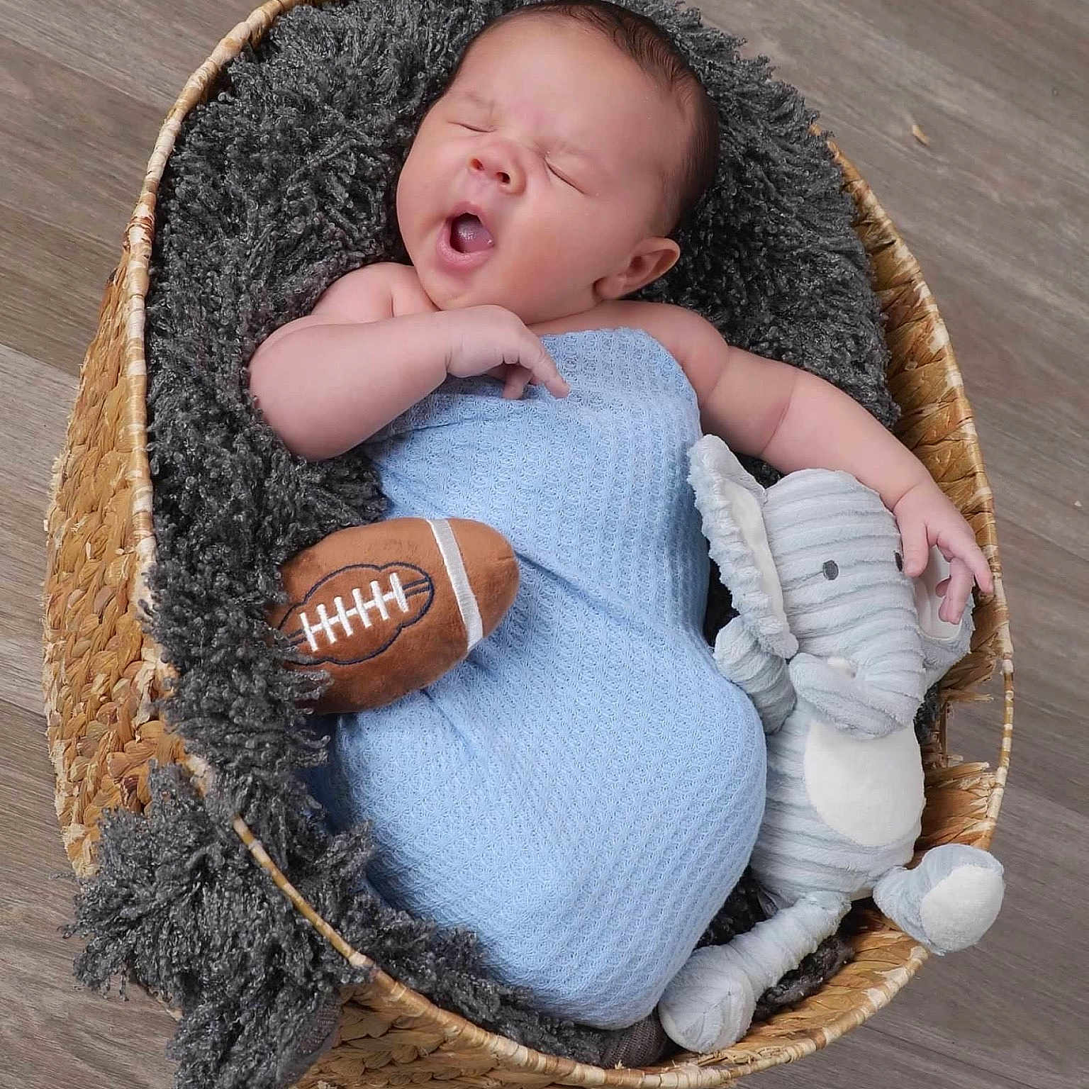 Grayson joined the competition — help win amazing prizes! americanfootball, americanfootballball, baby, ball, basket, crib, face, football, furniture, head, infantbed, newborn, person, sport, yawning