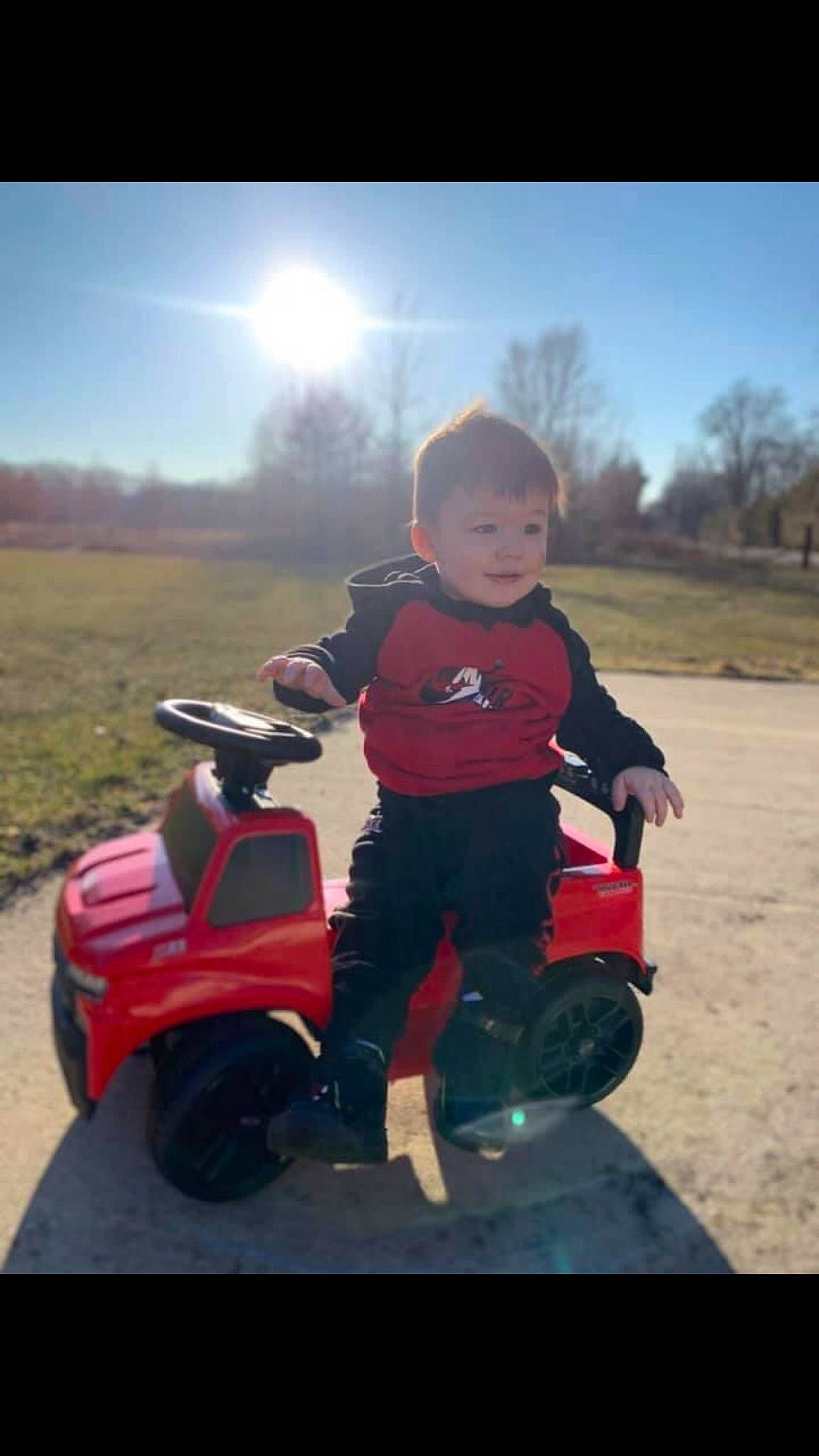 Zayden is registered to the contest to win money with this photo: automotive_design, automotive_exterior, automotive_lighting, automotive_tire, cloud, fender, grass, happy, light, motor_vehicle, nature, person, plant, rim, rolling, sky, tire, travel, tree, vehicle