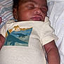 Trelyn is registered to the contest to win money with this photo: baby, newborn, sleeping, onesie, dinosaur, clothing, infant, child, cute, peaceful, blanket, bed, resting, skin, face, arm, portrait, indoors, soft, cozy