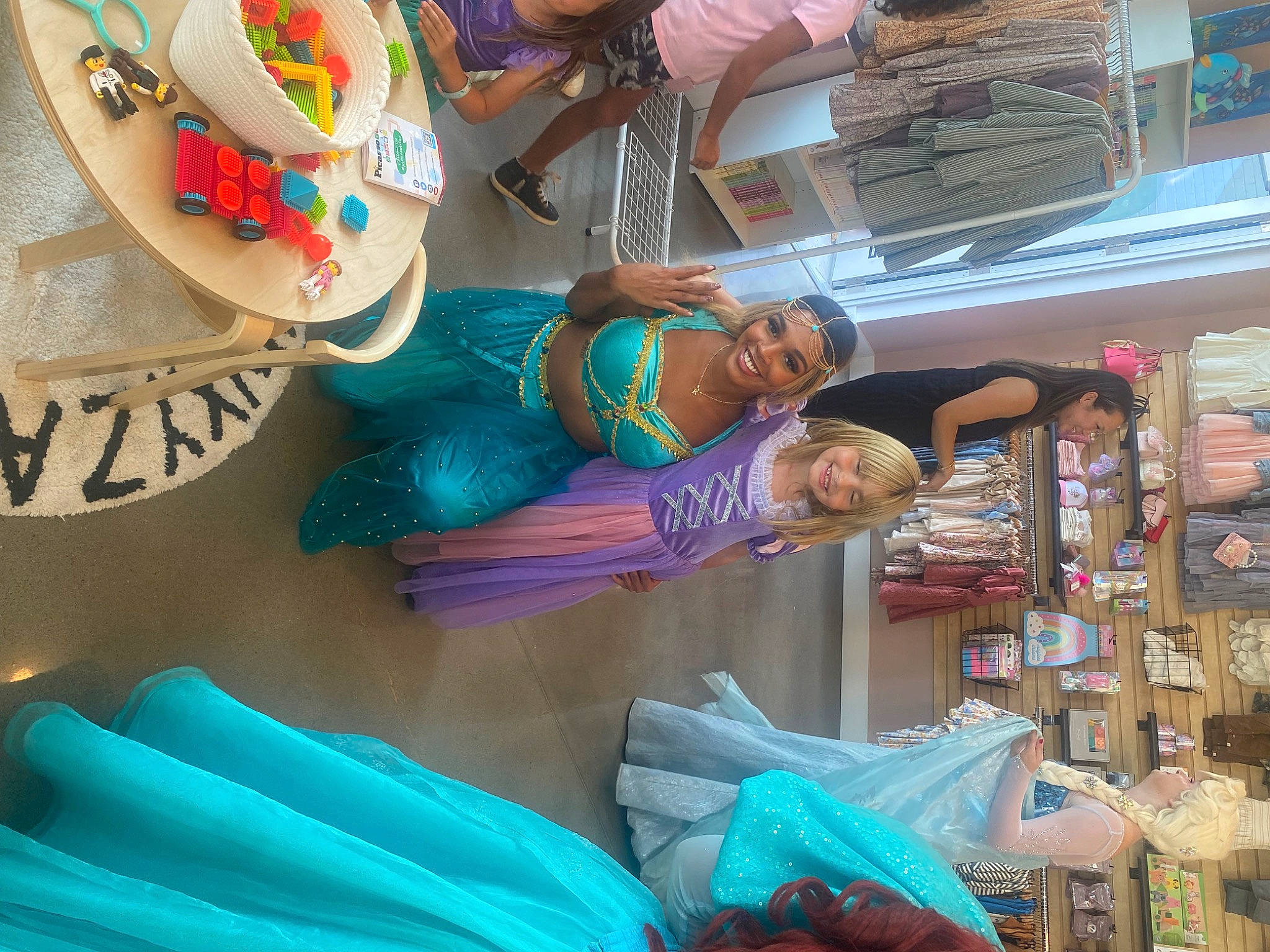 Scout is registered to the contest to win money with this photo: child, circle, city, customer, event, fun, hat, headwear, joy, leisure, market, marketplace, person, plastic, retail, room, selling, shopkeeper, smile, t_shirt