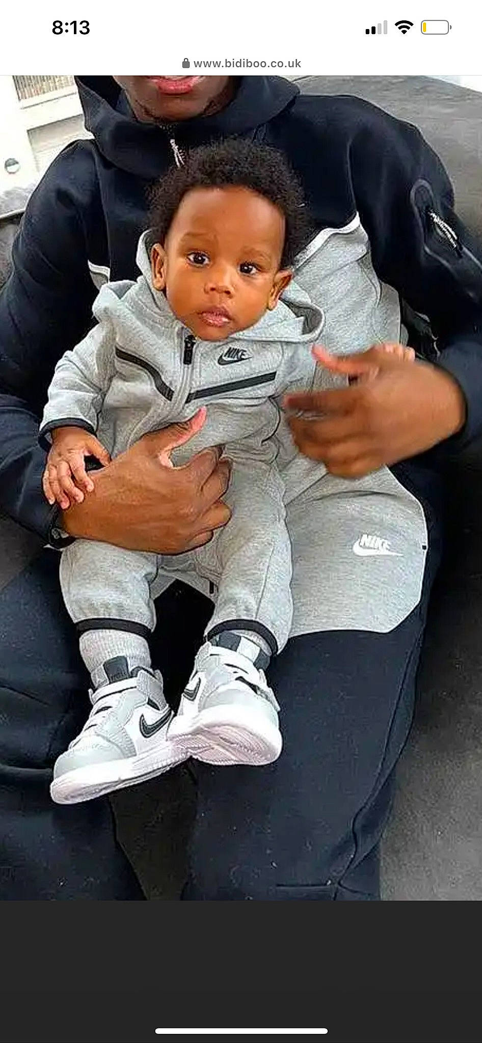 Cyprus is registered to the contest to win money with this photo: baby, baby_toddler_clothing, comfort, cool, facial_expression, gesture, head, joint, knee, lap, leg, person, shoe, skin, sleeve, sneakers, sock, thigh, thumb, toddler