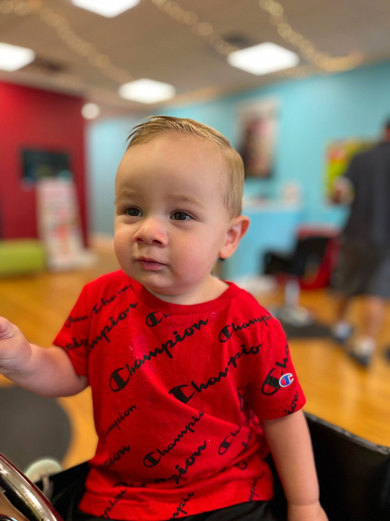 Bentley is registered to the contest to win money with this photo: baby, bicycle_saddle, bicycle_tire, child, event, fun, happy, leisure, motor_vehicle, person, recreation, riding_toy, room, sitting, skin, sleeve, t_shirt, toddler