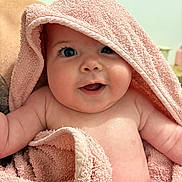 Mya participe au concours pour gagner de l'argent avec cette photo : arms, baby, blanket, child, closeup, cute, expression, face, happy, head, indoors, infant, person, pink, portrait, skin, smile, soft, towel, wet