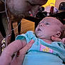 Kenzley joined the competition — help win amazing prizes! baby, man, face, person, indoor, clothing, earphones, bandana, beard, holding, table, chair, light, skin, expression, hand, tattoo, onesie, closeup, interaction