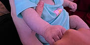 Kenzley is registered to the contest to win money with this photo: baby, infant, child, hand, arm, onesie, person, indoor, holding, tattoo, bracelet, curious, expression, skin, face, fist, reaching, couch, clothing, human