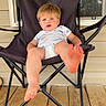 Berkley joined the competition — help win amazing prizes! toddler, child, chair, folding_chair, porch, wooden_floor, foot, baby, outdoor, daylight, casual, relaxed, curious, onesie, black_chair, smiling, person, seat, young_child, home