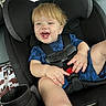 toddler, child, car_seat, blue_clothing, smiling, happy, blond_hair, seatbelt, car_interior, cup_holder, sitting, portrait, baby, young_child, casual, fun, hands, feet, vehicle, seat