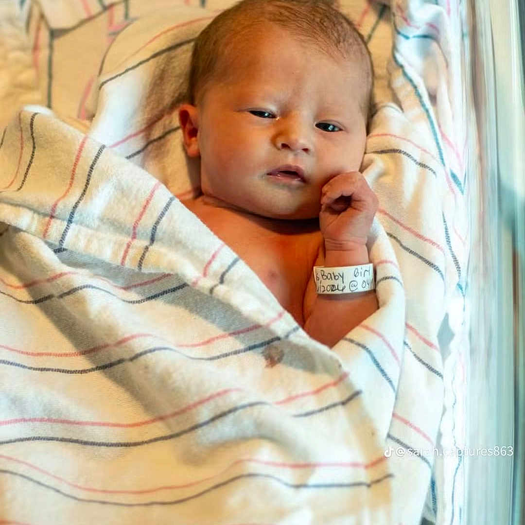 Daia joined the competition — help win amazing prizes! newborn, baby, infant, child, face, portrait, lying_down, blanket, hospital, wristband, sleeping, awake, wide_eyes, hand, skin, striped_fabric, indoor, photograph, maternity, birth