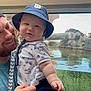 Zander joined the competition — help win amazing prizes! baby, man, child, hat, bucket_hat, beard, smile, water, rocks, people, outdoor, exhibit, aquarium, reflection, shirt, hand, holding, adult, casual_clothing, happy