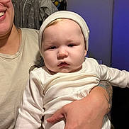 Zander joined the competition — help win amazing prizes! baby, child, person, adult, tattoo, hat, white_clothing, smile, hand, indoor, face, holding, long_sleeve, cozy, portrait, human, expression, skin, casual, candid