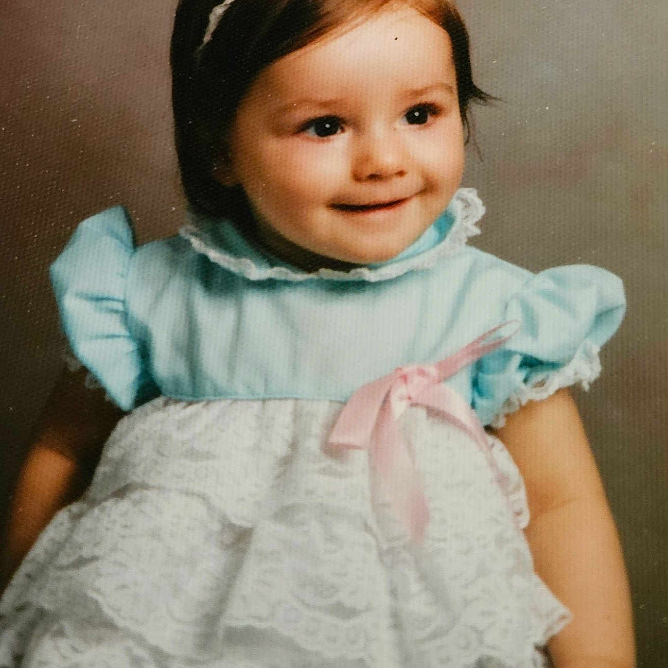 Leslie is registered to the contest to win money with this photo: accessories, blouse, bonnet, child, clothing, costume, dress, face, female, formalwear, girl, happy, hat, head, headband, lace, person, photography, portrait, smile