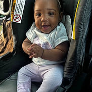 Dlizuh joined the competition — help win amazing prizes! baby, child, car_seat, smile, headband, toddler, clothing, hands, person, cute, indoors, seat, happy, portrait, infant, car_interior, sitting, apparel, young_child, bright