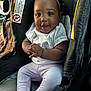 baby, child, car_seat, smile, headband, toddler, clothing, hands, person, cute, indoors, seat, happy, portrait, infant, car_interior, sitting, apparel, young_child, bright