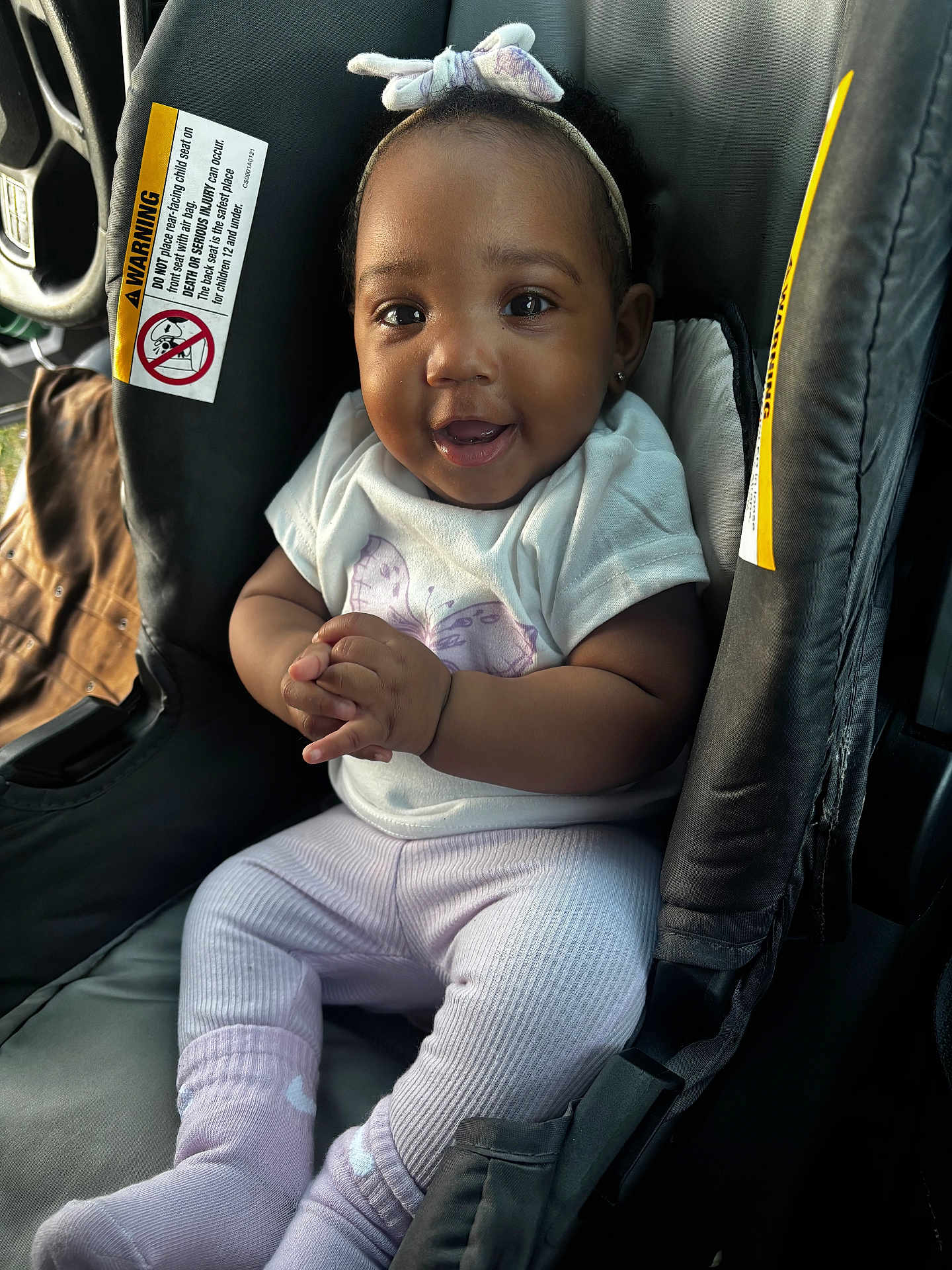 Dlizuh joined the competition — help win amazing prizes! baby, child, car_seat, smile, headband, toddler, clothing, hands, person, cute, indoors, seat, happy, portrait, infant, car_interior, sitting, apparel, young_child, bright