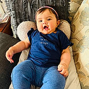 Avleen Kaur Gill is registered to the contest to win money with this photo: baby, child, headband, blue_shirt, leggings, couch, pillow, indoor, cute, chubby, expression, sitting, comfort, face, person, clothing, home, smile, happy, young_child