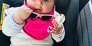Avleen Kaur Gill joined the competition — help win amazing prizes! baby, car_seat, child, clothing, pink_bib, sunglasses, hair_clip, white_outfit, seatbelt, car_interior, cute, infant, portrait, child_seat, car, young_child, person, sitting, hand, face