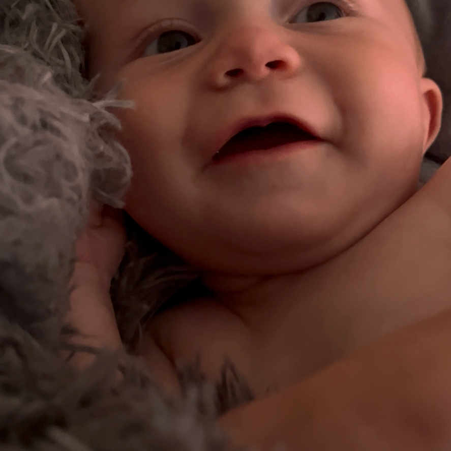 Weldyn is registered to the contest to win money with this photo: baby, blanket, child, childhood, close_up, comfort, cozy, cute, expression, face, happy, indoors, infant, newborn, portrait, skin, smile, soft_texture, warm, young