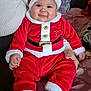 Giovanni a rejoint le concours — aidez-le/la à gagner de superbes lots ! baby, child, santa_outfit, red_clothing, hat, smile, indoor, bed, blanket, person, cute, holiday, christmas, festive, cozy, chubby_cheeks, black_socks, white_trim, portrait, happy