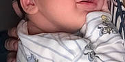 Giovanni participe au concours pour gagner de l'argent avec cette photo : newborn, baby, sleeping, onesie, mickey_mouse, cartoon, stripes, person, closeup, face, hand, cute, infant, clothing, resting, soft, comfort, warm, parent, holding