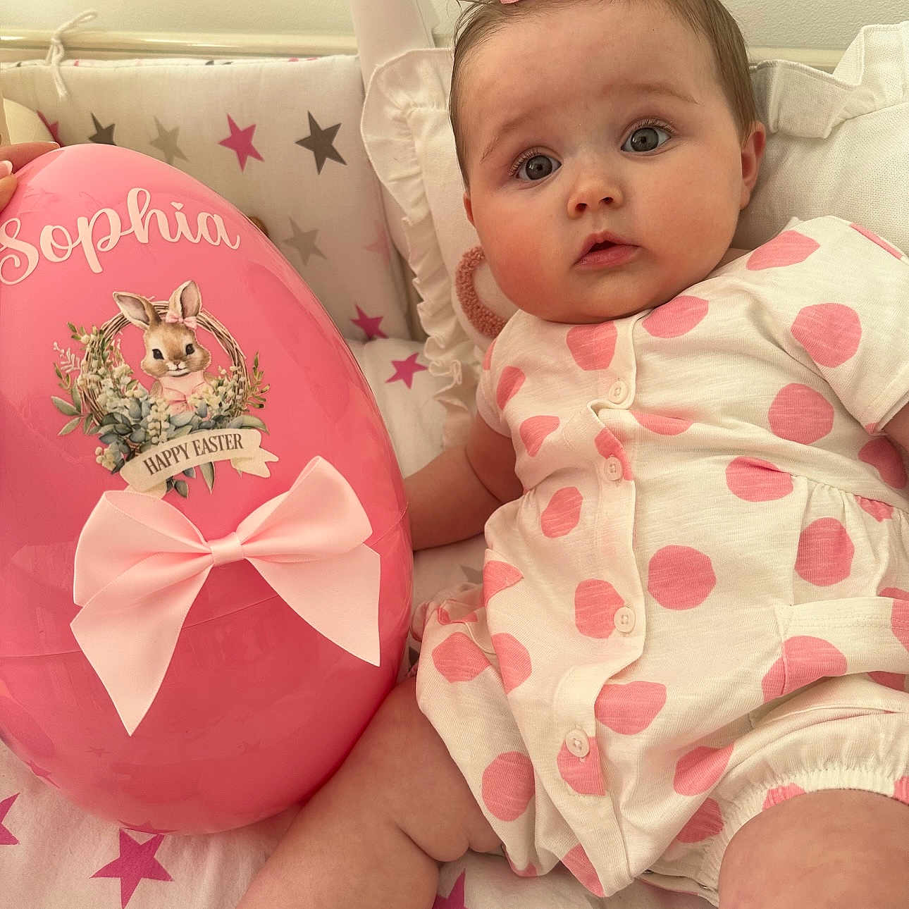 Sophia joined the competition — help win amazing prizes! baby, balloon, bed, clothing, couch, crib, cushion, dress, face, furniture, head, homedecor, indoors, newborn, person, photography, pillow, portrait, sitting, toy
