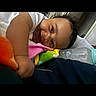 Mahlani is registered to the contest to win money with this photo: baby, blanket, bottle, child, clothing, colorful, comfort, cute, expression, face, happy, head, indoor, infant, lying_down, person, resting, smiling, soft, young_child