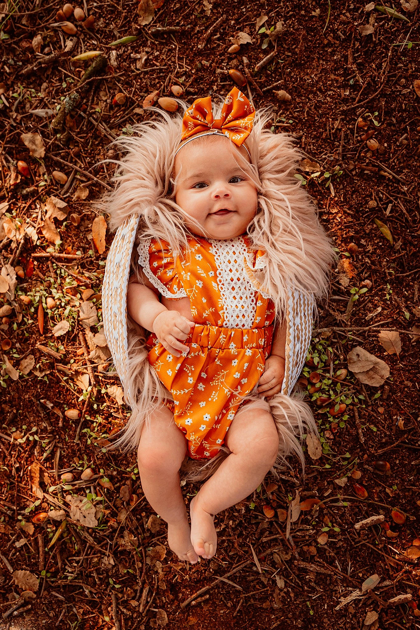 Anais participe au concours pour gagner de l'argent avec cette photo : baby, baby_toddler_clothing, botany, dress, face, fawn, foot, grass, grass_family, happy, human_body, human_leg, leaf, people_in_nature, person, plant, smile, toddler, tree, vertebrate