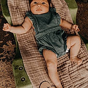 Rylee joined the competition — help win amazing prizes! baby, infant, two_months, headband, romper, lying_down, blanket, green, wooden_sign, milestone, cute, child, soft_lighting, portrait, indoors, foot, hand, skin, expression, cushion
