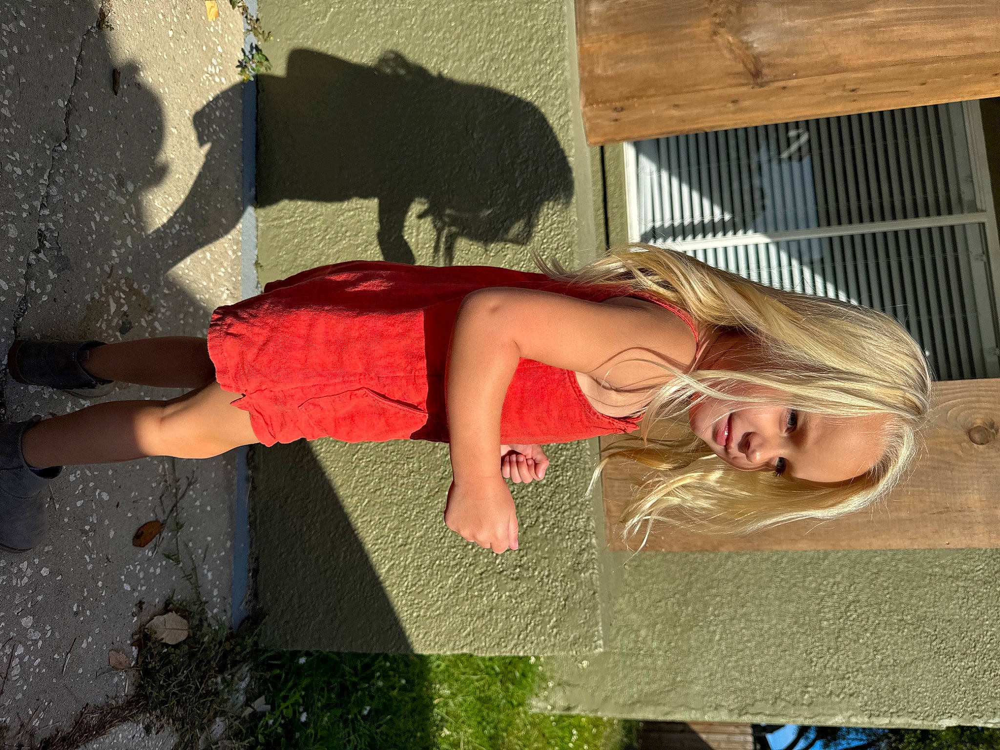 Evie is registered to the contest to win money with this photo: child, concrete, eyewear, fun, grass, happy, human_leg, leisure, people_in_nature, person, road_surface, shadow, sidewalk, thigh, tints_and_shades, trunk, vacation, visual_arts, waist, wood