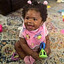 baby, bib, carpet, child, colorful, curly_hair, cute, floor, fun, happy, indoor, infant, person, pink, playful, portrait, sitting, smiling, soft_lighting, toy