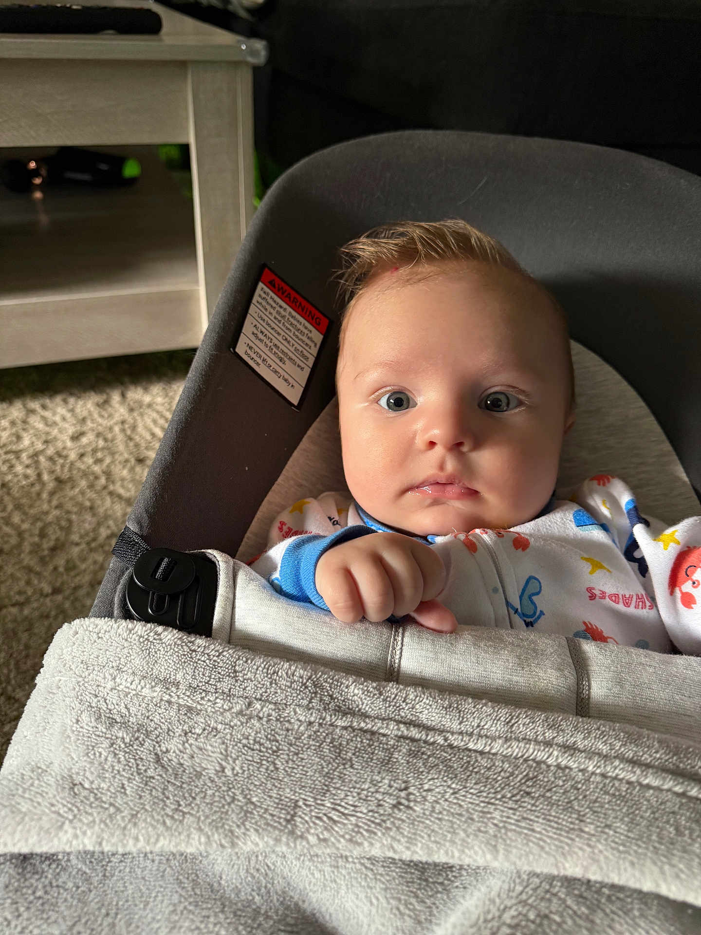Noah joined the competition — help win amazing prizes! baby, infant, blanket, baby_seat, face, indoor, carpet, furniture, curious, clothing, cushion, child, person, soft_lighting, expression, hand, head, seat_belt, comfort, portrait