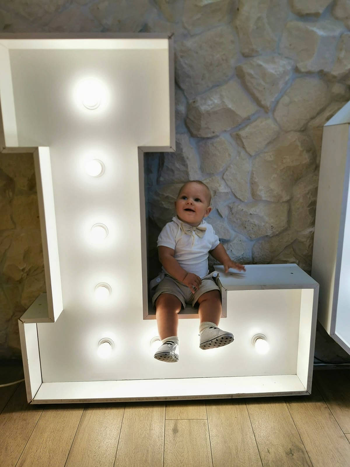 Leon is registered to the contest to win money with this photo: art, baby, ceiling, child, floor, flooring, hardwood, house, interior_design, knee, person, room, shorts, sitting, smile, space, t_shirt, toddler, visual_arts, wood