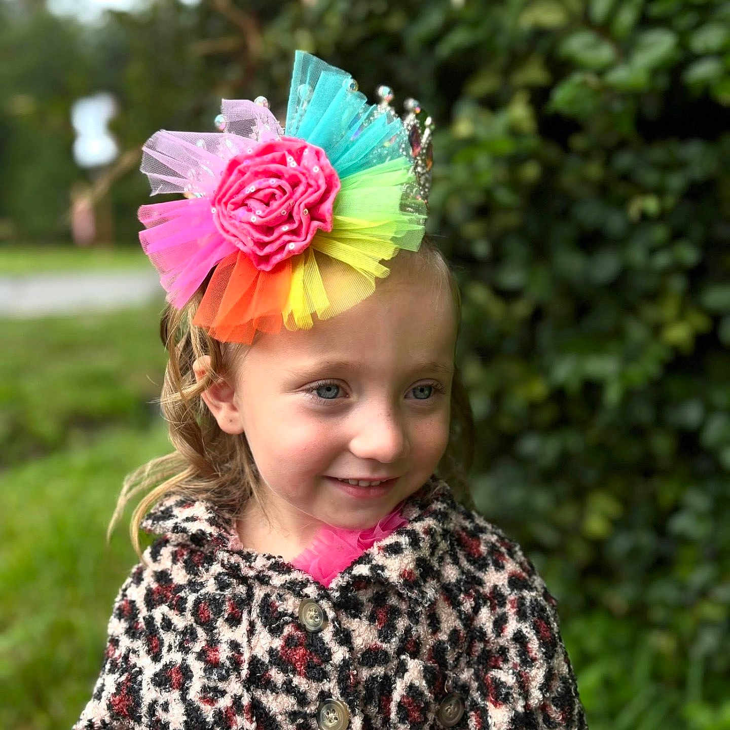 Valarie is registered to the contest to win money with this photo: buttoned_coat, child, coat, colorful, cute, daylight, face, fashion, flower_headpiece, girl, greenery, happy, headwear, leopard_print, nature, outdoor, person, portrait, smile, young