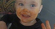 Echo joined the competition — help win amazing prizes! toddler, child, messy_face, high_chair, smiling, food, hand_raised, blue_eyes, indoor, clothing, hair, face, happy, expression, meal_time, cute, person, baby, dirt, playful