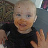 toddler, child, messy_face, high_chair, smiling, food, hand_raised, blue_eyes, indoor, clothing, hair, face, happy, expression, meal_time, cute, person, baby, dirt, playful