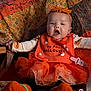 Harper is registered to the contest to win money with this photo: baby, infant, child, halloween, orange, headband, costume, quilt, blanket, sitting, sock, pacifier, cute, festive, holiday, tutu, knitwear, expression, indoors, portrait
