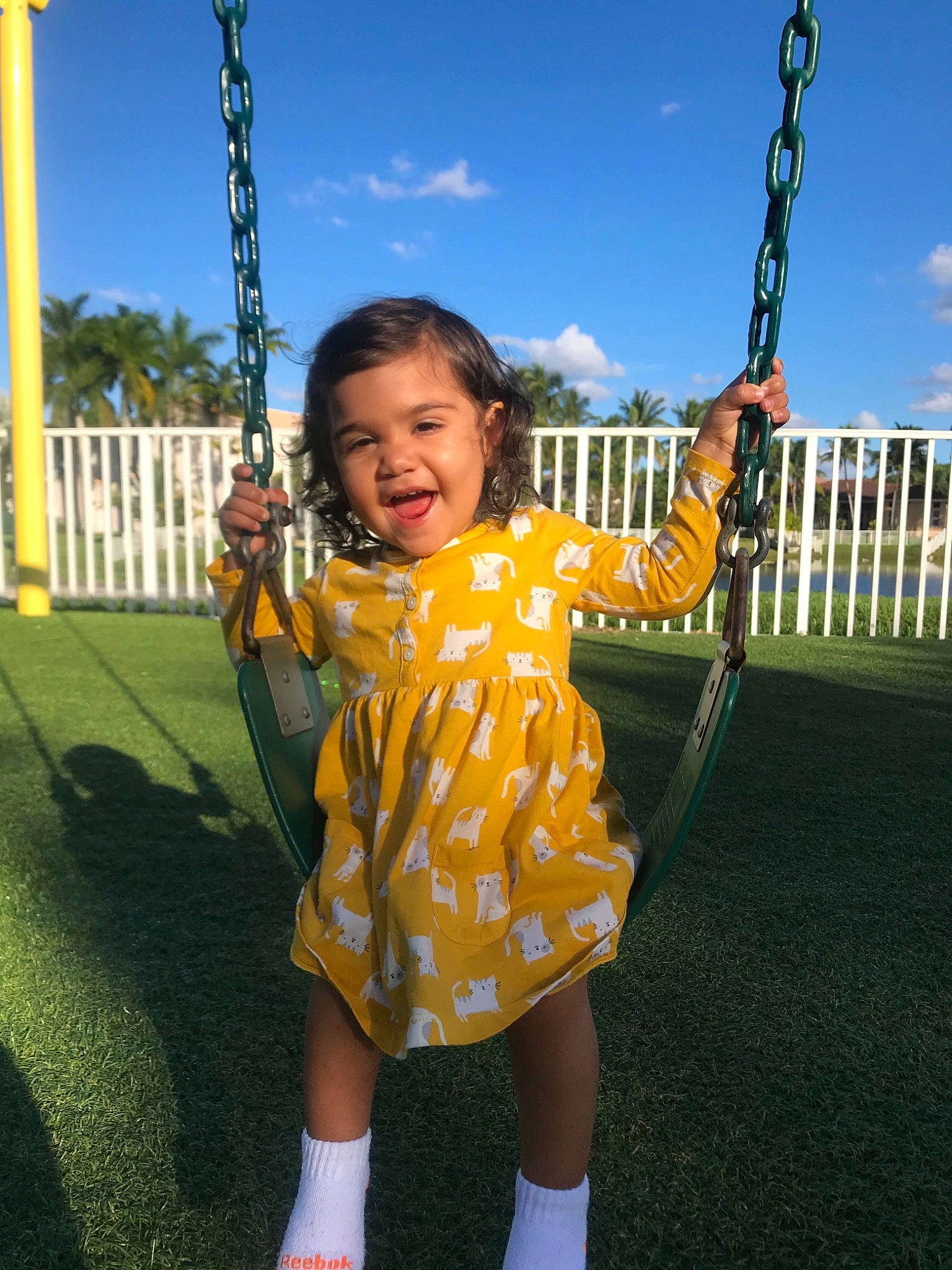 Olivia is registered to the contest to win money with this photo: child, fun, outdoor_play_equipment, person, playground, public_space, smile, swing, toddler