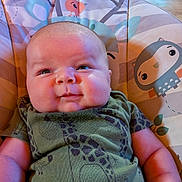 Kyle Jr joined the competition — help win amazing prizes! baby, infant, child, smile, seated, baby_chair, green_clothing, animal_print, indoor, couch, face, head, arm, furniture, comfort, cute, plush, young_child, portrait, happy
