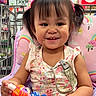 Cataleya Nykishia is registered to the contest to win money with this photo: toddler, child, smiling, shopping_cart, toy, bottle, pigtails, rainbow, colorful, store, cushion, clothing, person, indoor, happy, cute, baby, portrait, seat, playful