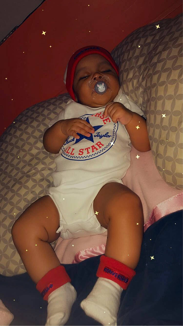 Lailani is registered to the contest to win money with this photo: abdomen, baby_toddler_clothing, chest, comfort, cool, elbow, fun, hat, headwear, human_leg, joint, knee, lap, leg, muscle, person, shoe, shorts, sock, thigh