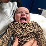 Olivia-May joined the competition — help win amazing prizes! baby, smiling, laughing, leopard_print, clothing, person, adult, hand, face, portrait, joy, happy, indoor, closeup, fabric, jacket, skin, expression, candid, human