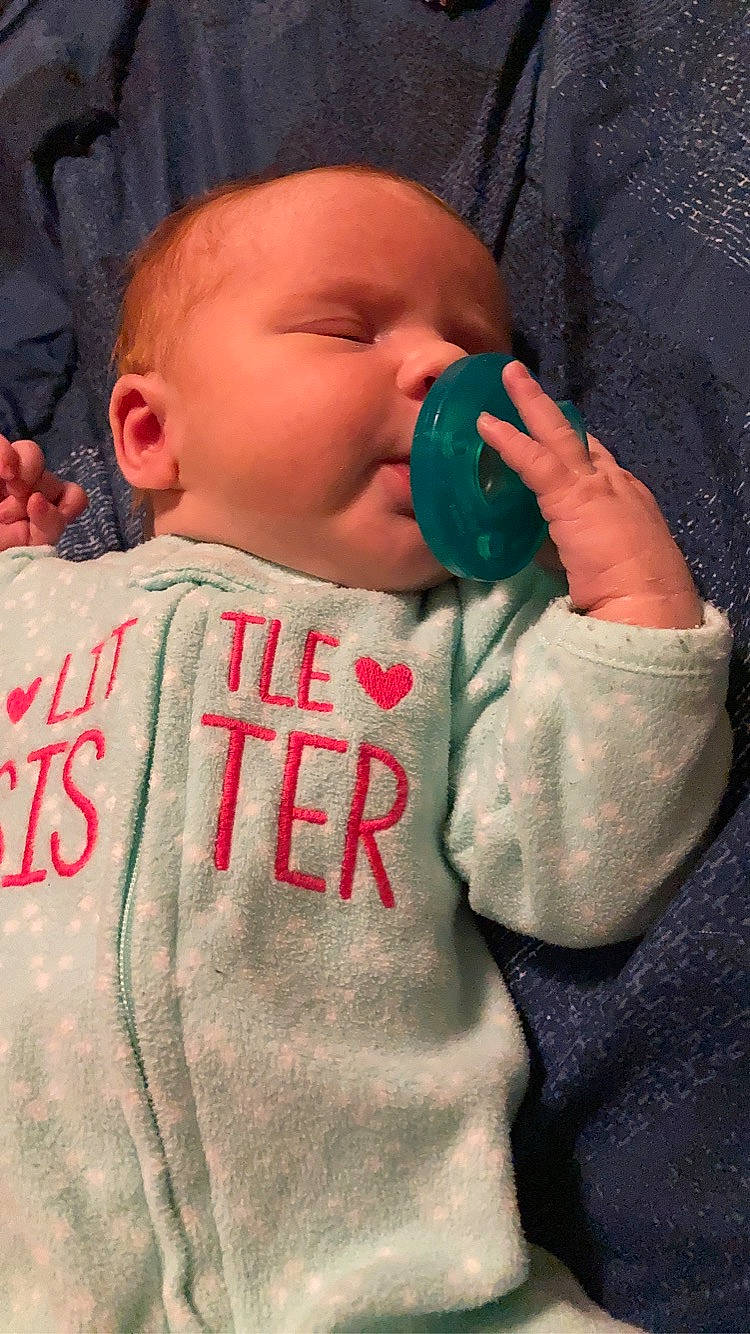 Everest is registered to the contest to win money with this photo: baby, baby_toddler_clothing, cheek, chin, drinkware, ear, eyebrow, face, finger, gesture, hand, happy, lip, mouth, nose, person, skin, sleeve, textile, thumb