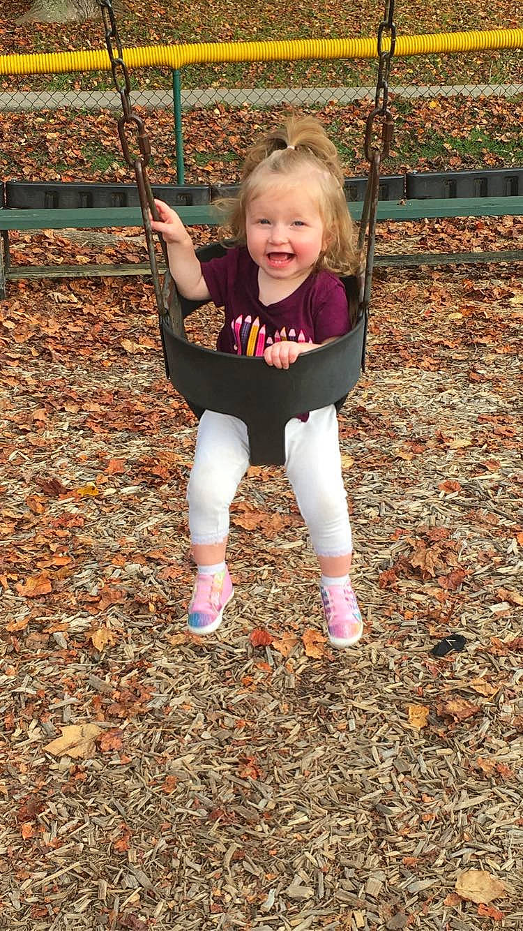 Sophia is registered to the contest to win money with this photo: baby, baby_toddler_clothing, blond, child, eye, face, fun, grass, happy, head, leaf, leisure, people_in_nature, person, playground, recreation, sleeve, smile, soil, toddler