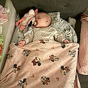 Thaïna participe au concours pour gagner de l'argent avec cette photo : baby, sleeping, blanket, mickey_mouse, minnie_mouse, pacifier, plush_toy, flamingo, cushion, pillow, infant, bed, soft_toy, child, comfort, indoor, cute, rest, nap, cozy