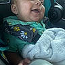 baby, child, infant, smiling, happy, portrait, car_seat, car, travel, blanket, fluffy_blanket, green_clothing, floral_pattern, safety_harness, seated, indoor, vehicle, close_up, face, photography